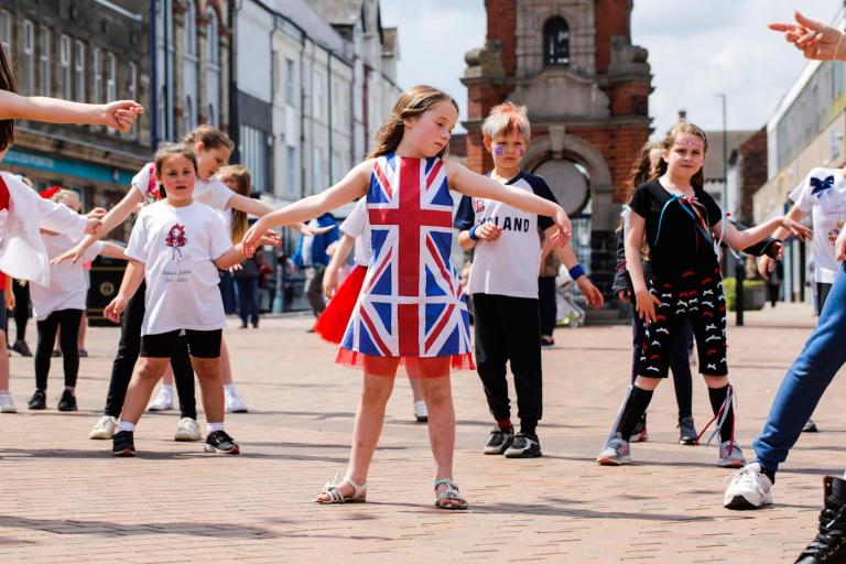 Children doing a choreographed dance at the flash mob show on Redcar High Street in celebration of the Platinum Jubilee.