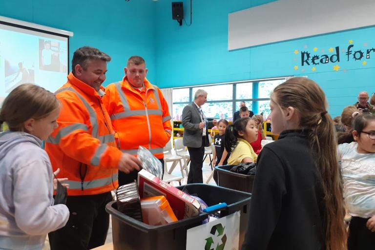 Recycling officers, guiding South Bank Primary pupils to sort out the waste items as part of the recycling game.