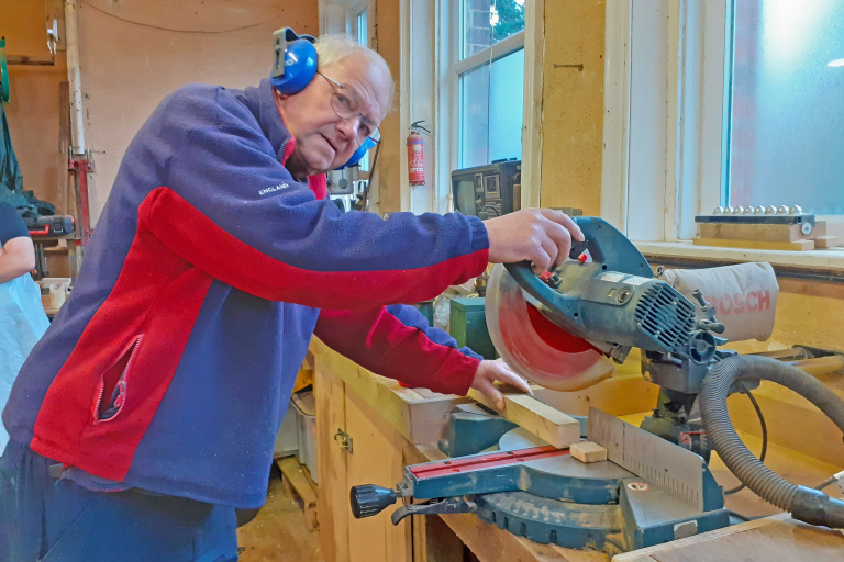 Mike Baggett, volunteer for the Margrove Wild Workshops Project, cutting wood for a bird box