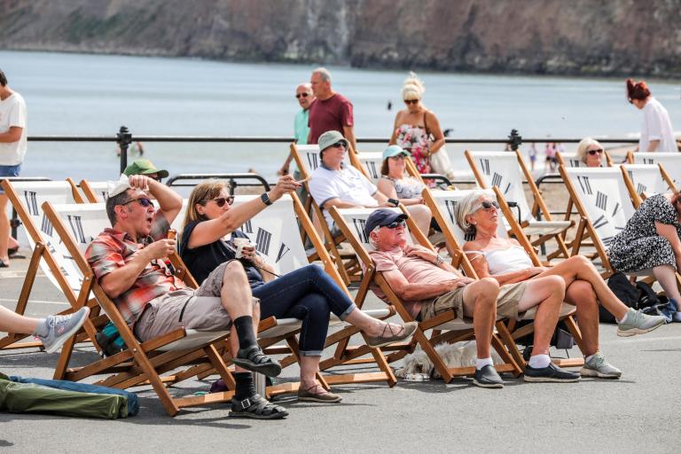 Crowds at the Road Race watching the race from beach chairs.