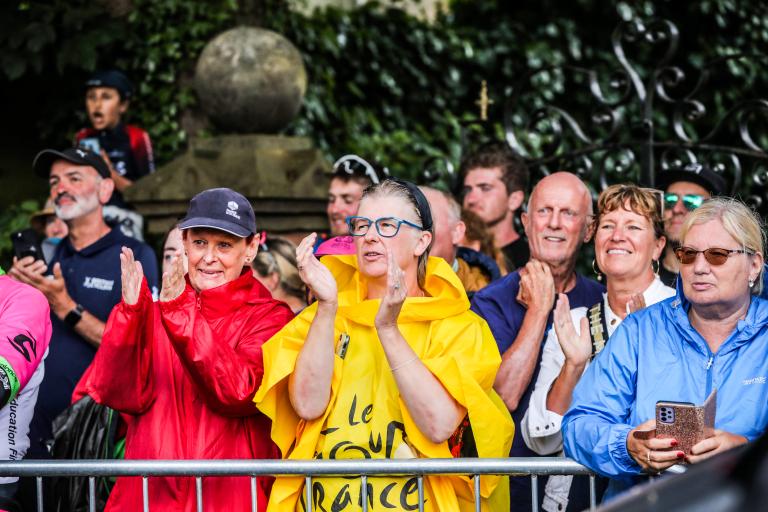 Crowds dressed in colourful raincoats watching the Road Race