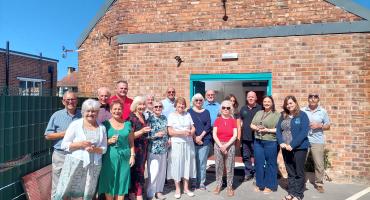 Image of the volunteers from FOSCO together with the locals and representatives of the organisations who supported the project, in front of the newly refurbished shed