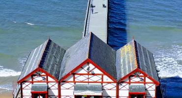 Image of the Saltburn tramway and pier with the sea in the background.