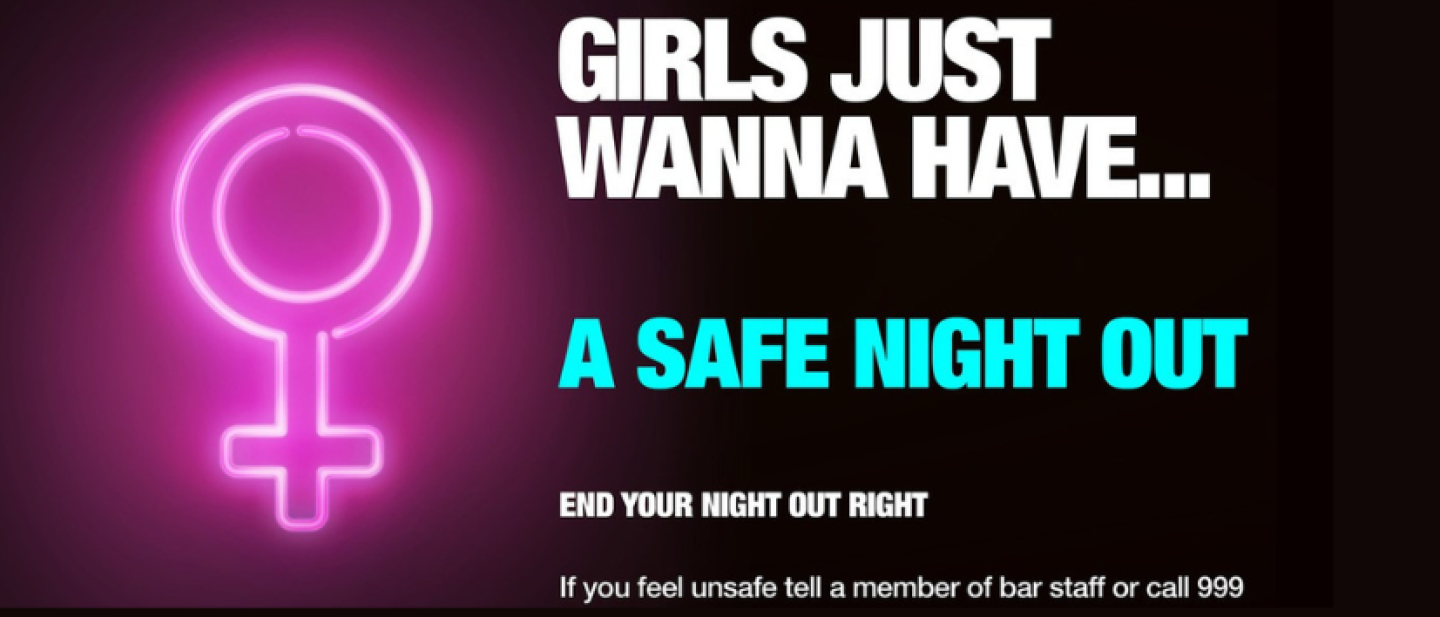 Poster reads: "Girls just wanna have... a safe night out. End your night right. If you feel unsafe, tell a member of staff or call 999.""